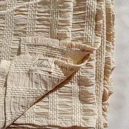 Top stitched beige bed throw